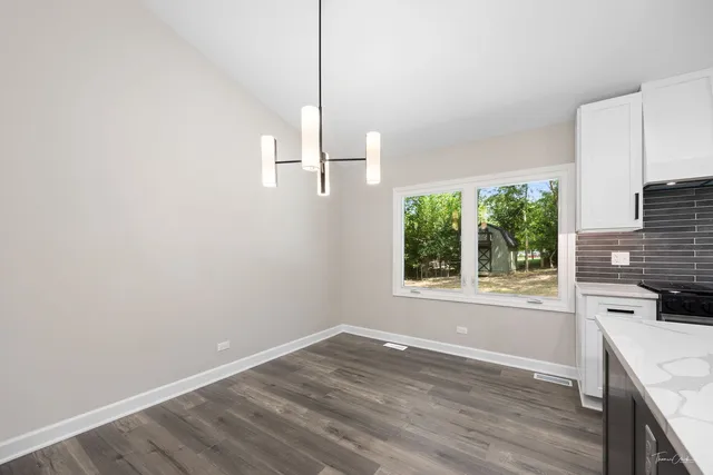 a view of kitchen with wooden floor and window