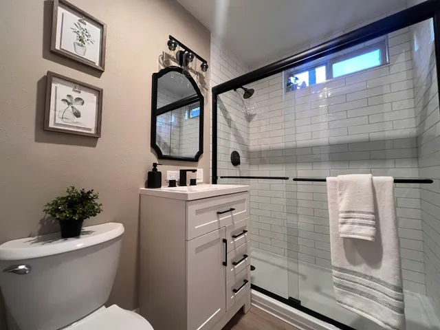 a bathroom with a sink mirror and toilet