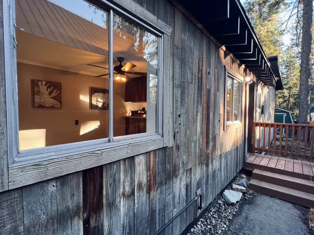 a view of a house with a wooden fence