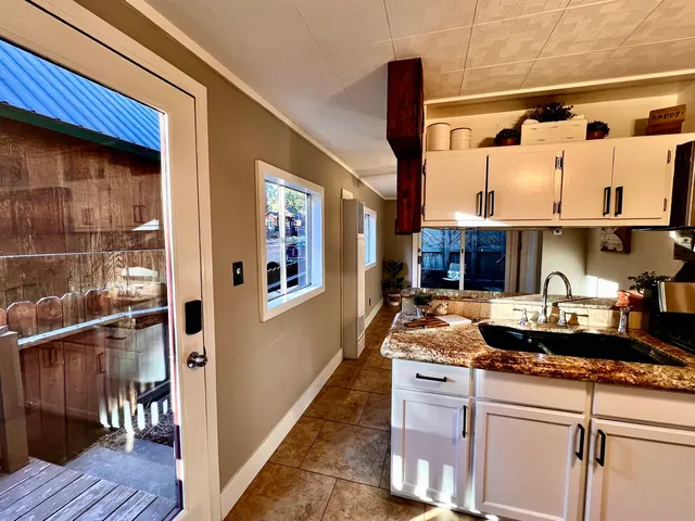a kitchen with sink stove and cabinets