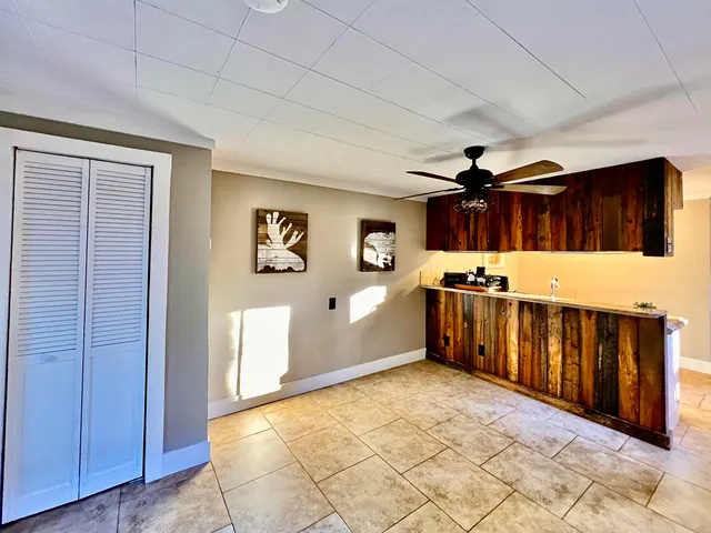 a view of a kitchen with furniture and wooden floor