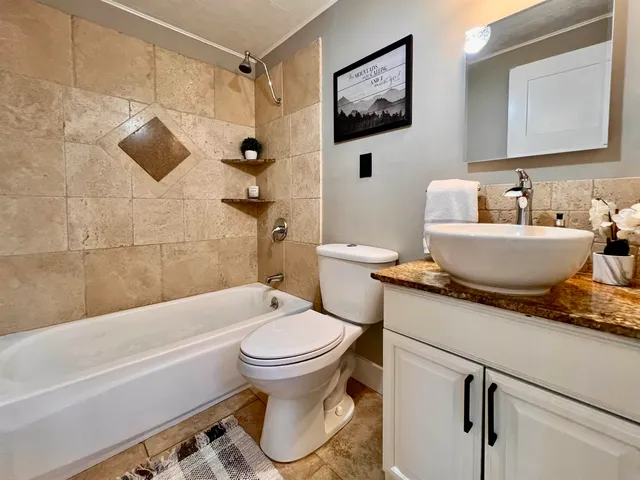 a bathroom with a sink toilet and shower