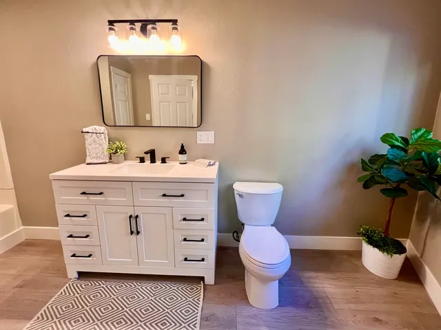 a bathroom with a toilet sink and mirror