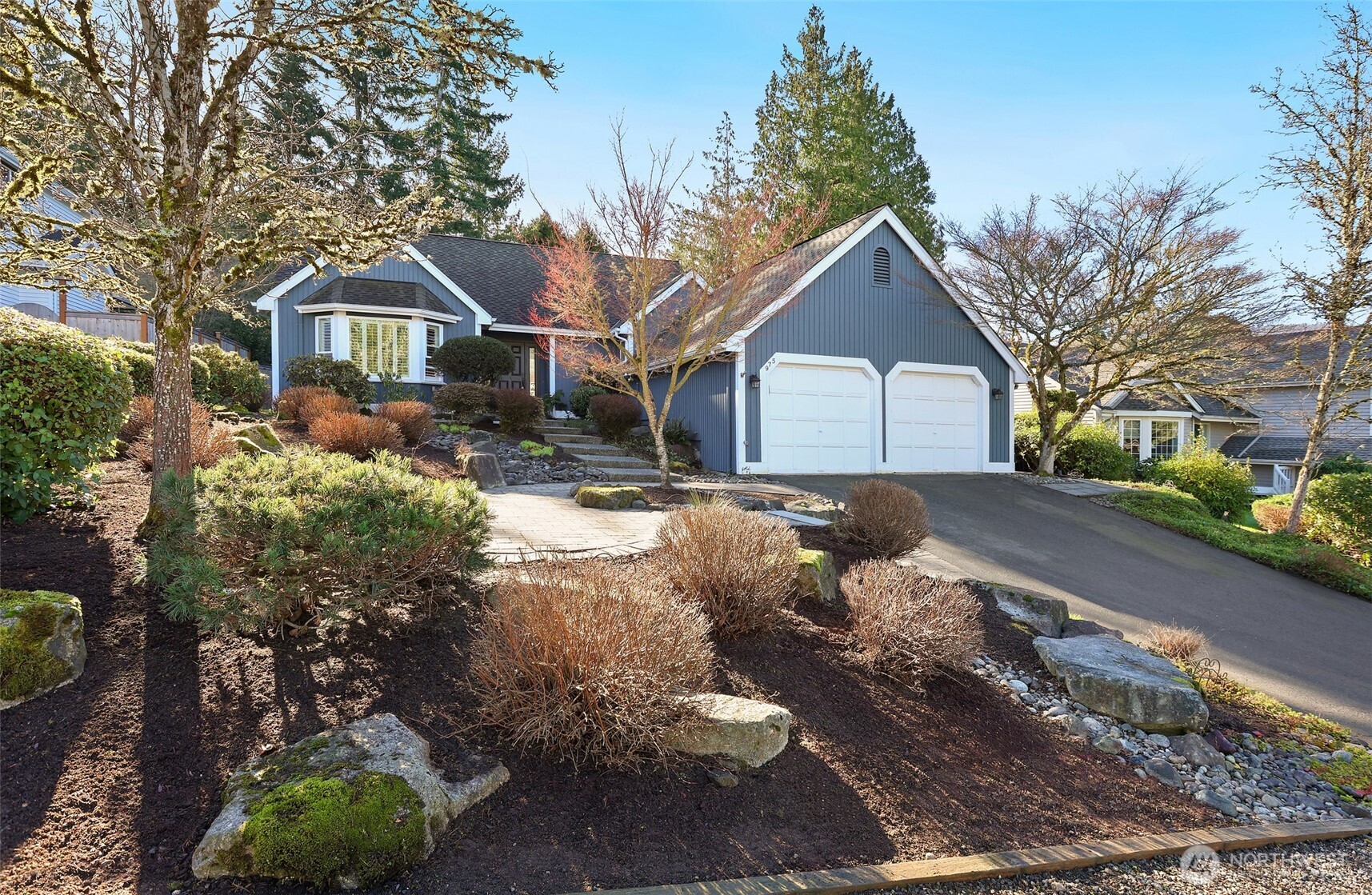 a front view of a house with a yard and garage