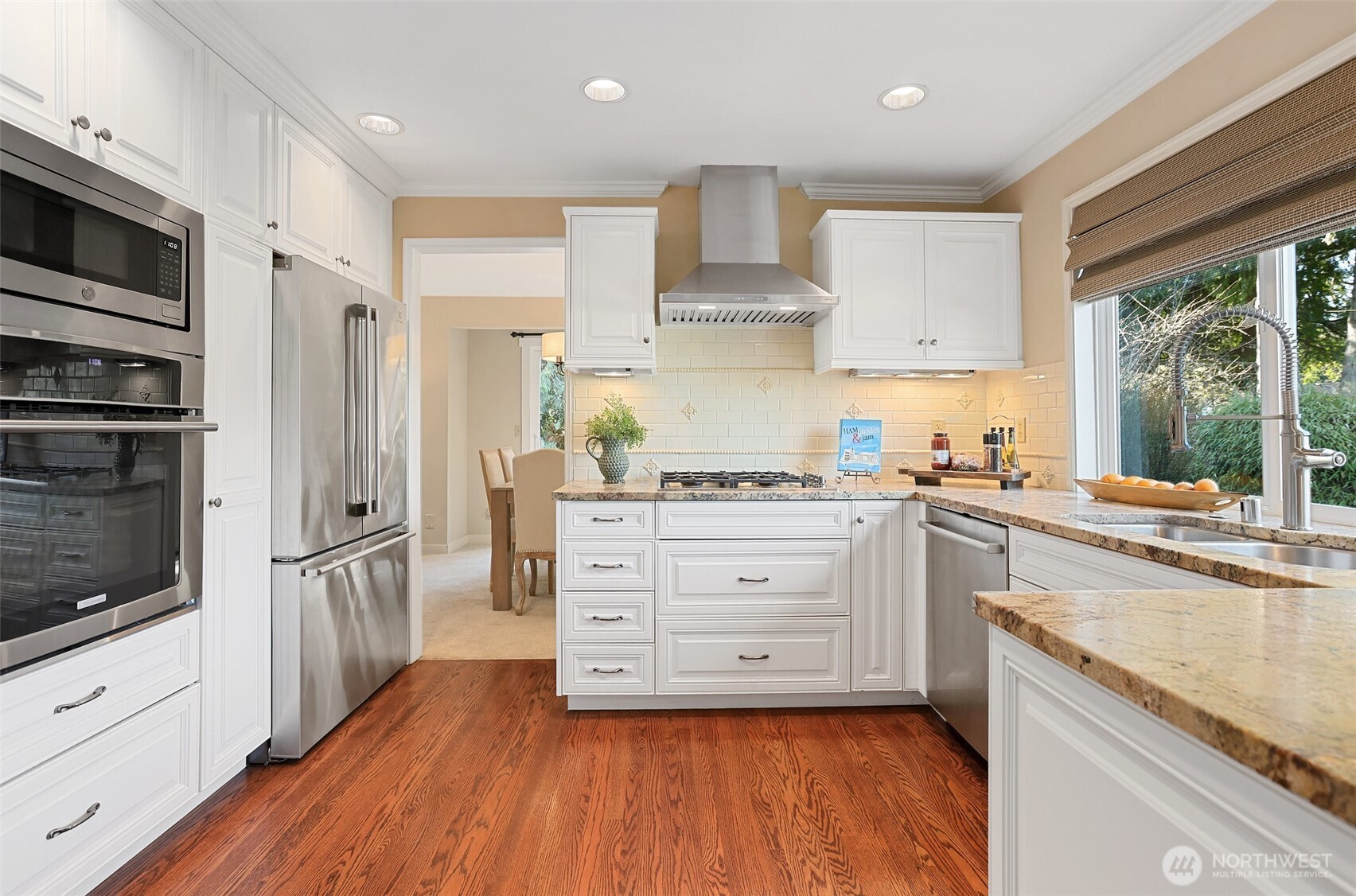 975 Northwest Inneswood Place Issaquah, WA 98027 - Photo 6 of 21 a kitchen with stainless steel appliances white cabinets and wooden floors
