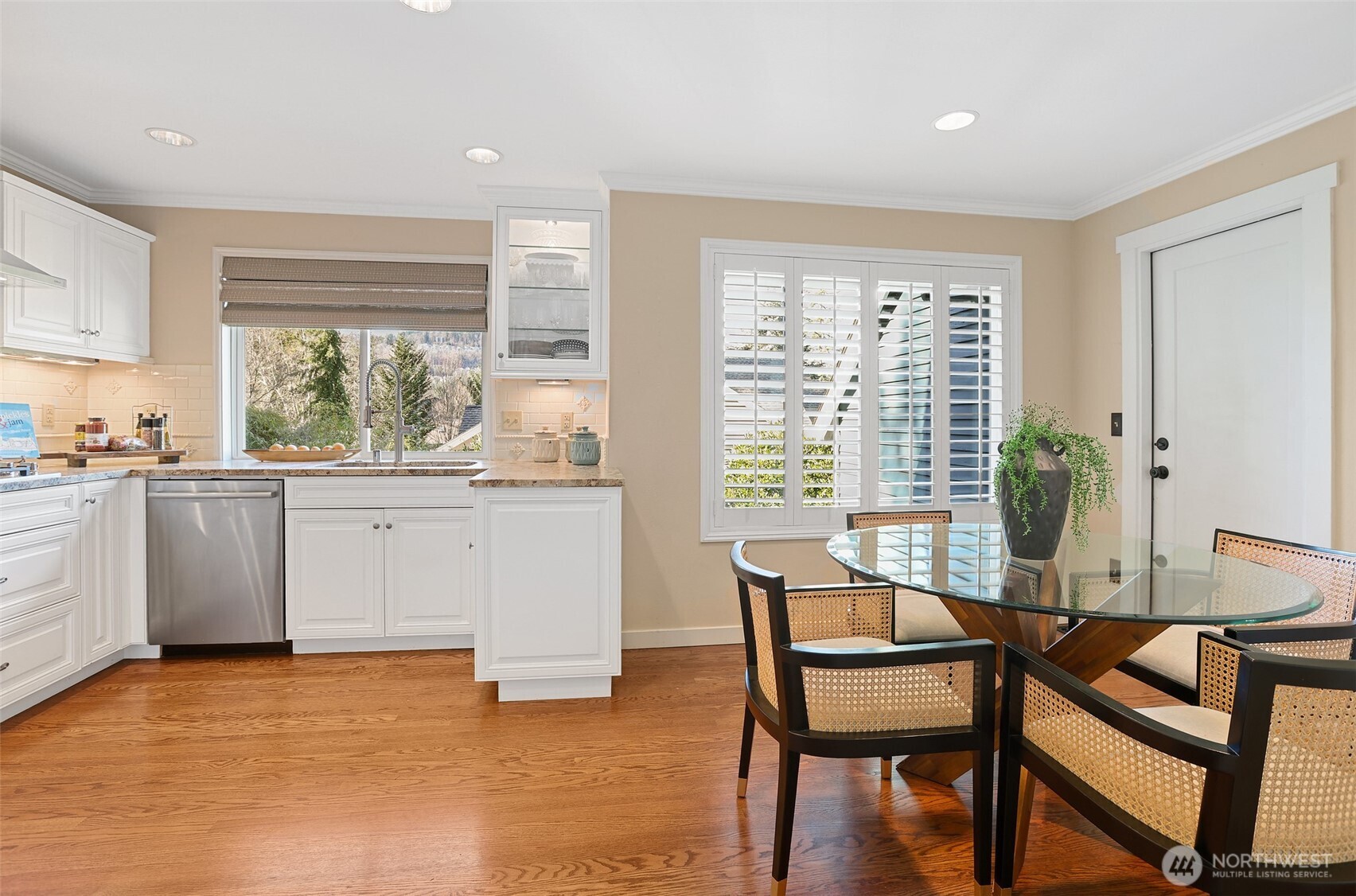 975 Northwest Inneswood Place Issaquah, WA 98027 - Photo 7 of 21 a kitchen with a table chairs sink and cabinets