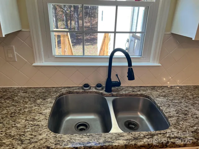 a bathroom with a sink and a window