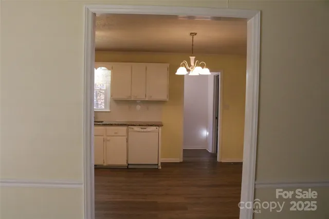 a view of a kitchen with a sink and a mirror