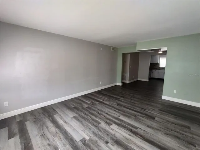 a view of a room with wooden floor