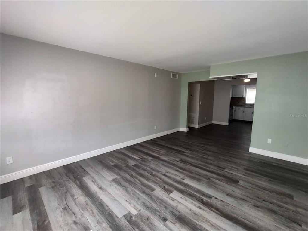 320 West Howry Avenue, Unit 1 Deland, FL 32720 - Photo 12 of 33 a view of a room with wooden floor