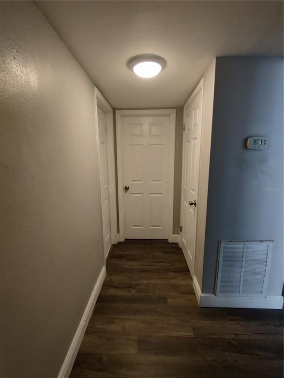 320 West Howry Avenue, Unit 1 Deland, FL 32720 - Photo 16 of 33 a view of a hallway with wooden floor and staircase