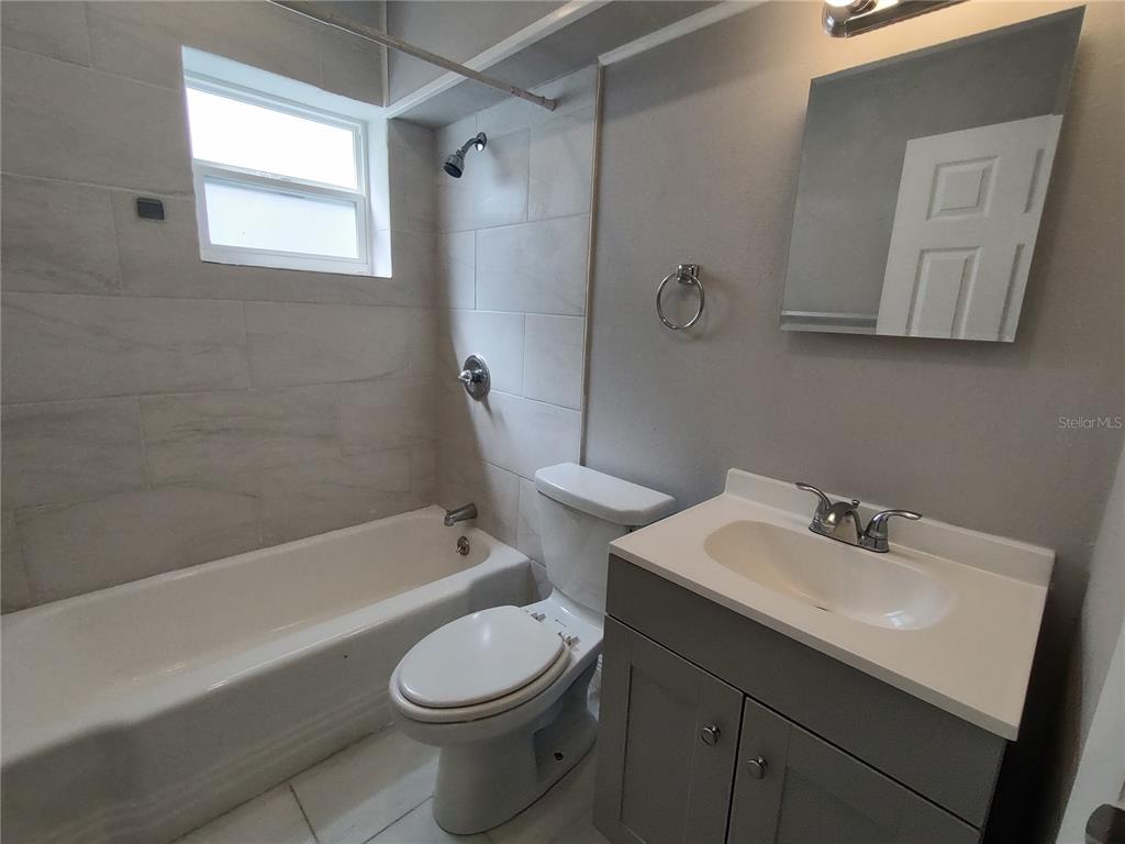 320 West Howry Avenue, Unit 1 Deland, FL 32720 - Photo 23 of 33 a bathroom with a sink a toilet and shower