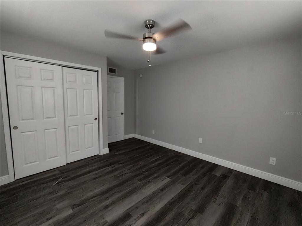 320 West Howry Avenue, Unit 1 Deland, FL 32720 - Photo 26 of 33 a view of an empty room with wooden floor