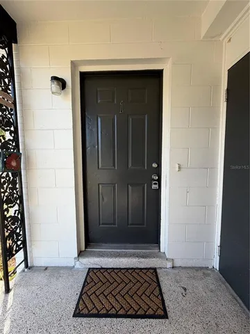 a view of a white house with a yard