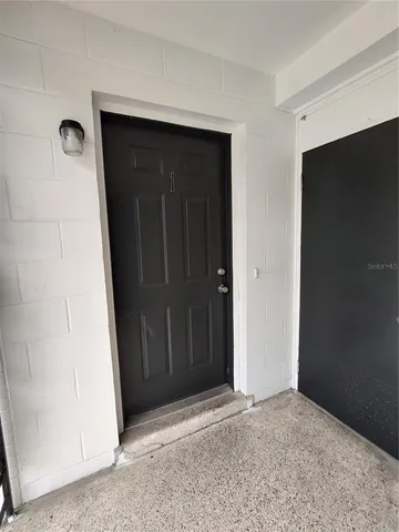 a view of a white house with a yard