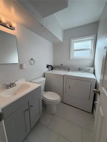 a view of a bathroom with a sink toilet and mirror