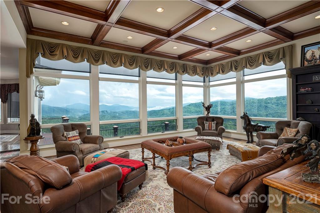 125 Stone Brook Trail Black Mountain, NC 28711 - Photo 15 of 48 a living room with furniture and floor to ceiling windows