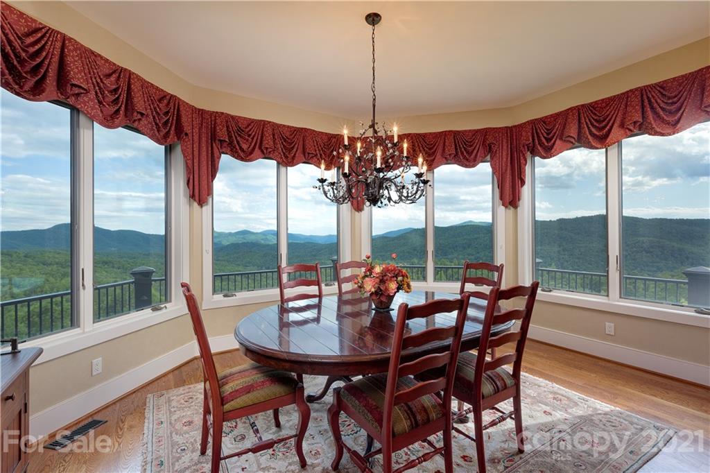125 Stone Brook Trail Black Mountain, NC 28711 - Photo 16 of 48 a view of a dining room with furniture large windows and wooden floor