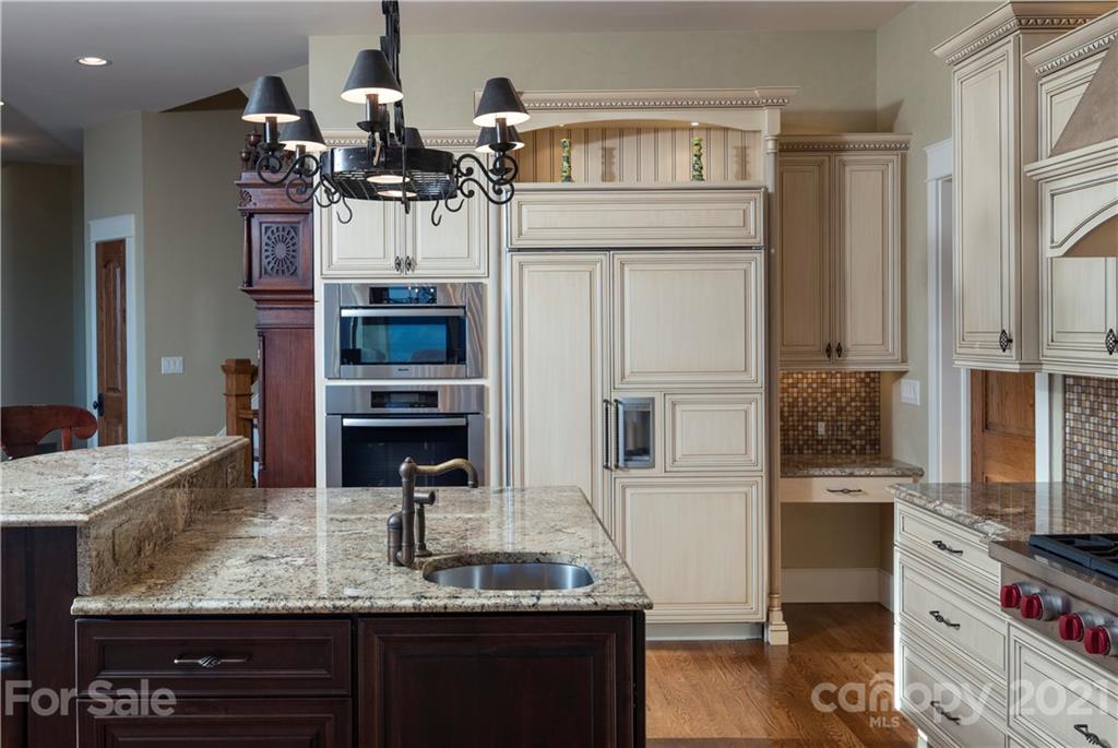 125 Stone Brook Trail Black Mountain, NC 28711 - Photo 18 of 48 a kitchen with kitchen island granite countertop counter top space cabinets and stainless steel appliances