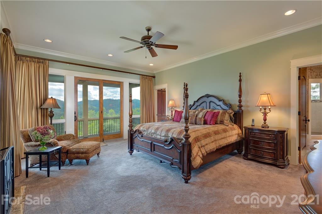 125 Stone Brook Trail Black Mountain, NC 28711 - Photo 24 of 48 a bedroom with a bed and a chandelier