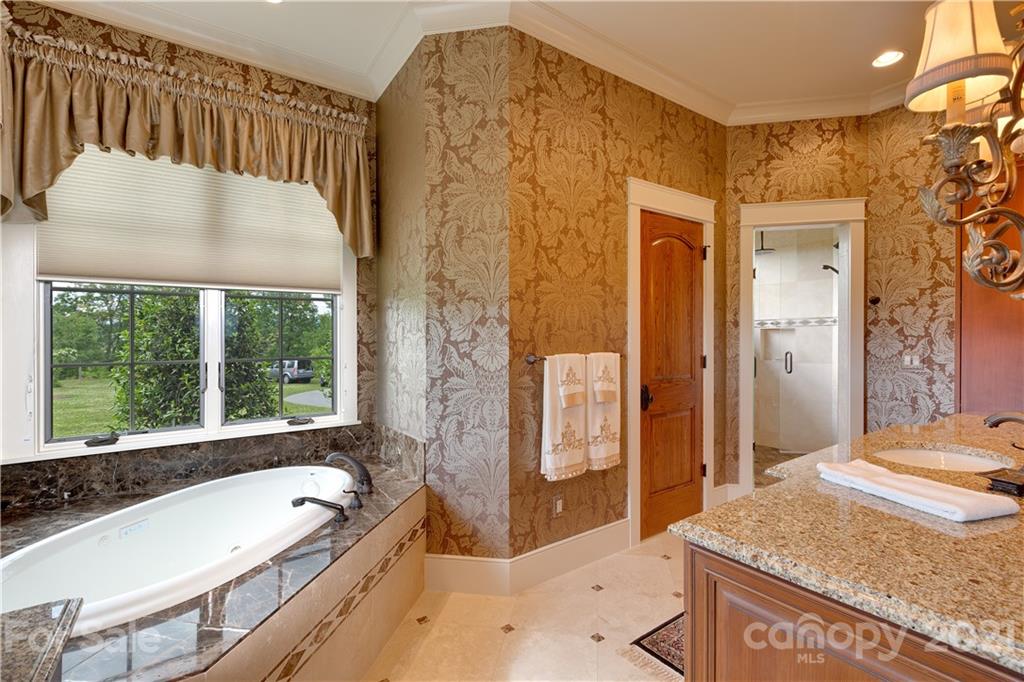 125 Stone Brook Trail Black Mountain, NC 28711 - Photo 26 of 48 a spacious bathroom with a granite countertop tub shower and sink