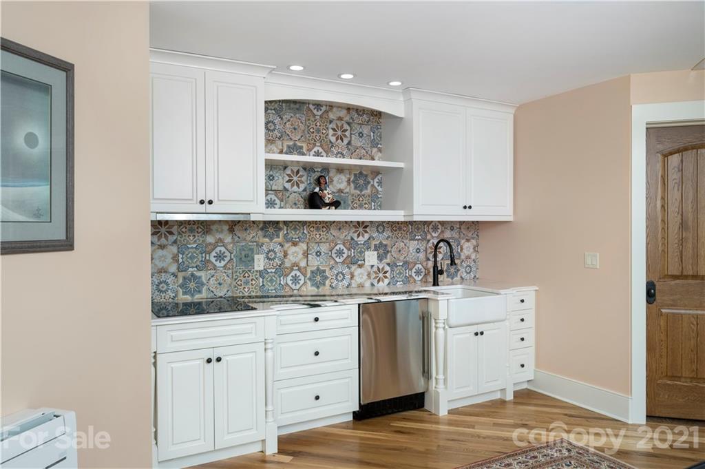 125 Stone Brook Trail Black Mountain, NC 28711 - Photo 37 of 48 a kitchen with white cabinets and sink