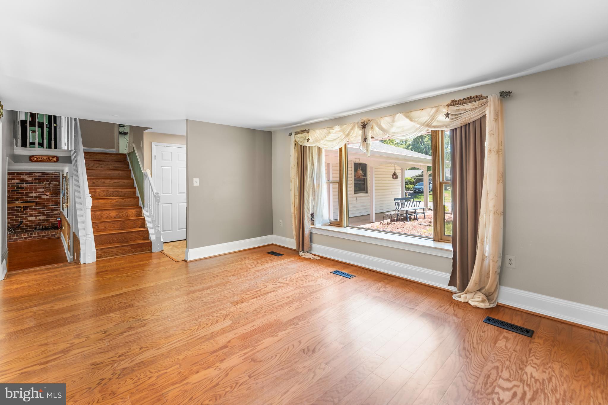 5922 Michael Road Waldorf, MD 20601 - Photo 11 of 43 an empty room with wooden floor and windows