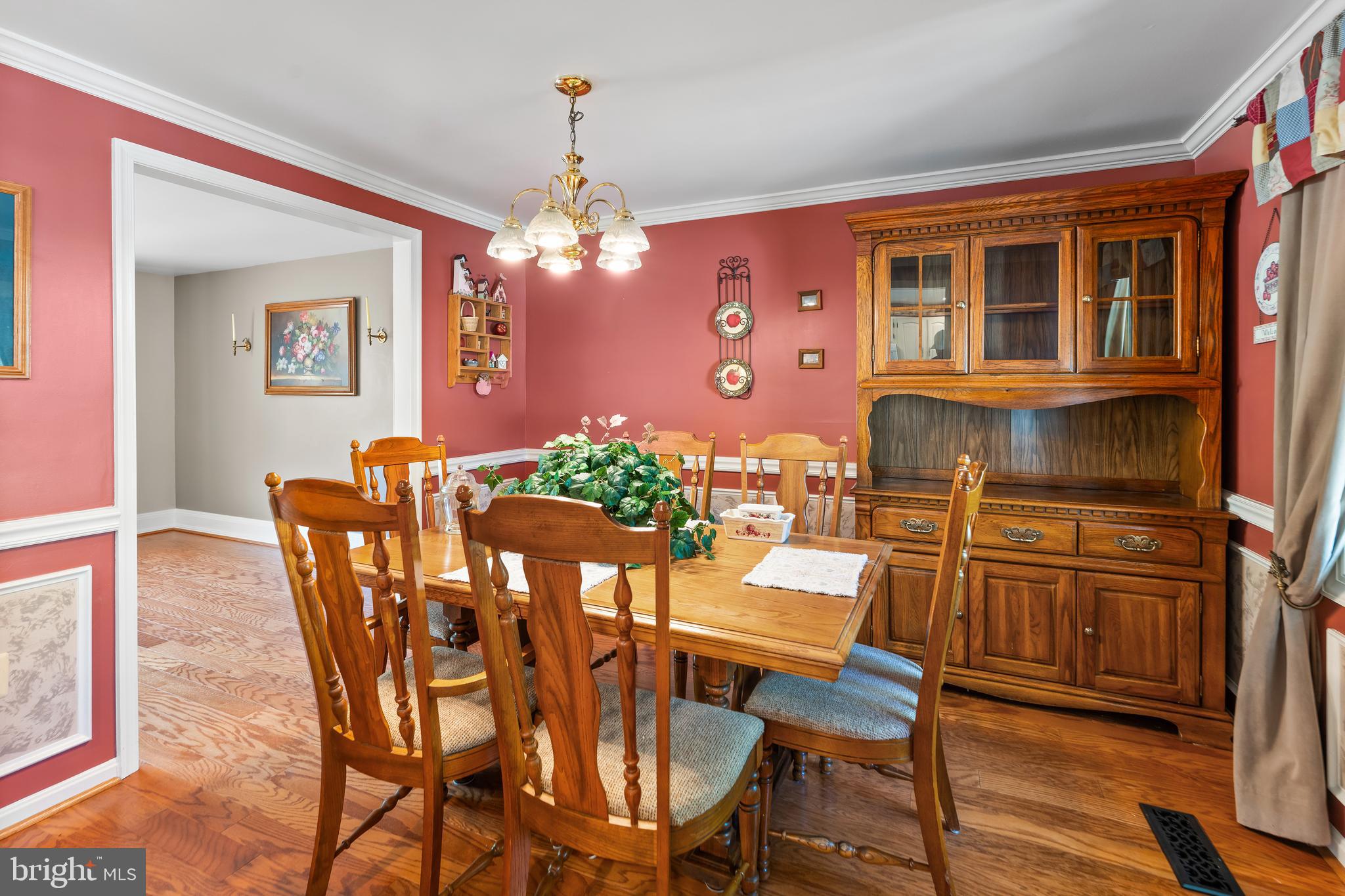 5922 Michael Road Waldorf, MD 20601 - Photo 13 of 43 a view of a dining room with furniture a chandelier and wooden floor