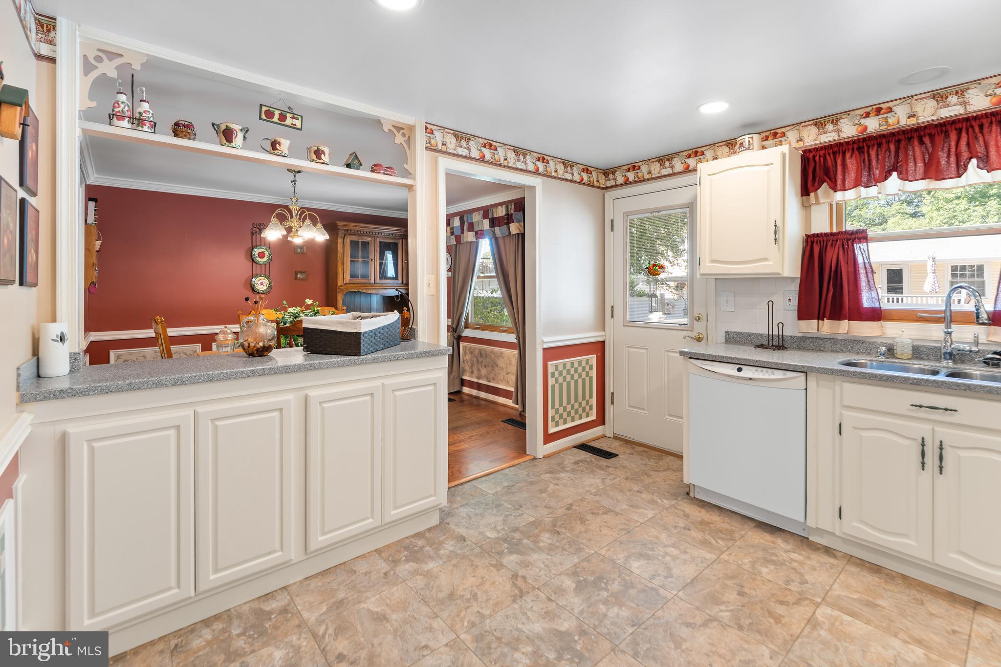 5922 Michael Road Waldorf, MD 20601 - Photo 14 of 43 a large white kitchen with granite countertop a sink and dishwasher a stove with wooden floors