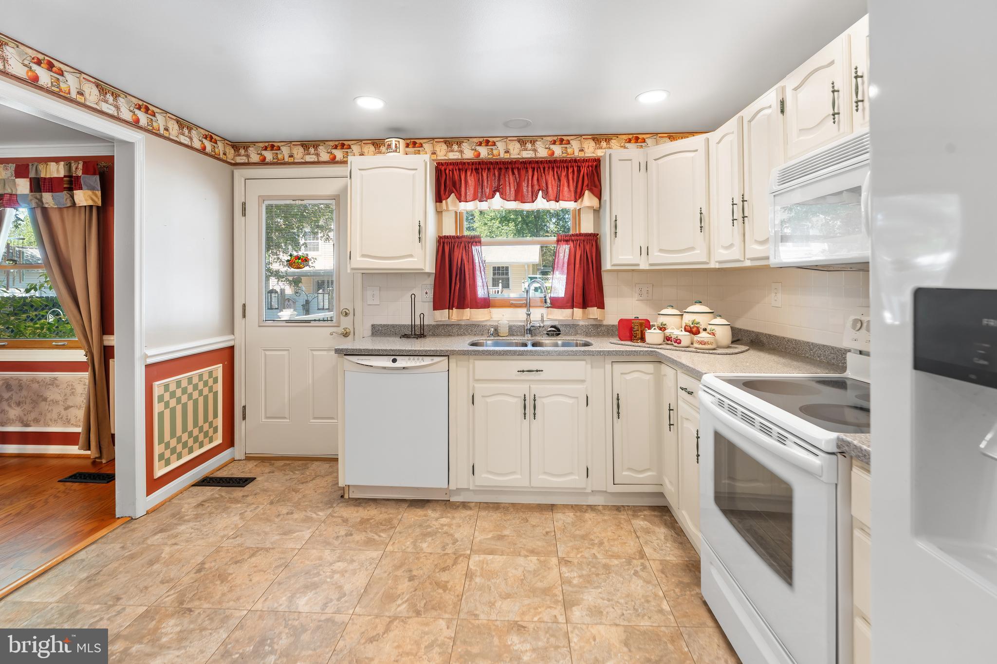 5922 Michael Road Waldorf, MD 20601 - Photo 15 of 43 a kitchen with stainless steel appliances granite countertop a stove a sink and a refrigerator