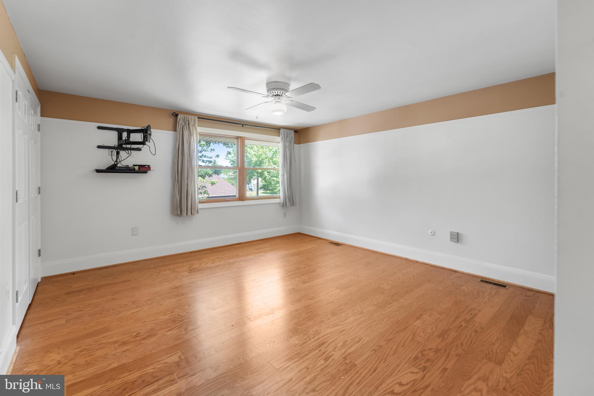 5922 Michael Road Waldorf, MD 20601 - Photo 19 of 43 an empty room with windows and ceiling fan