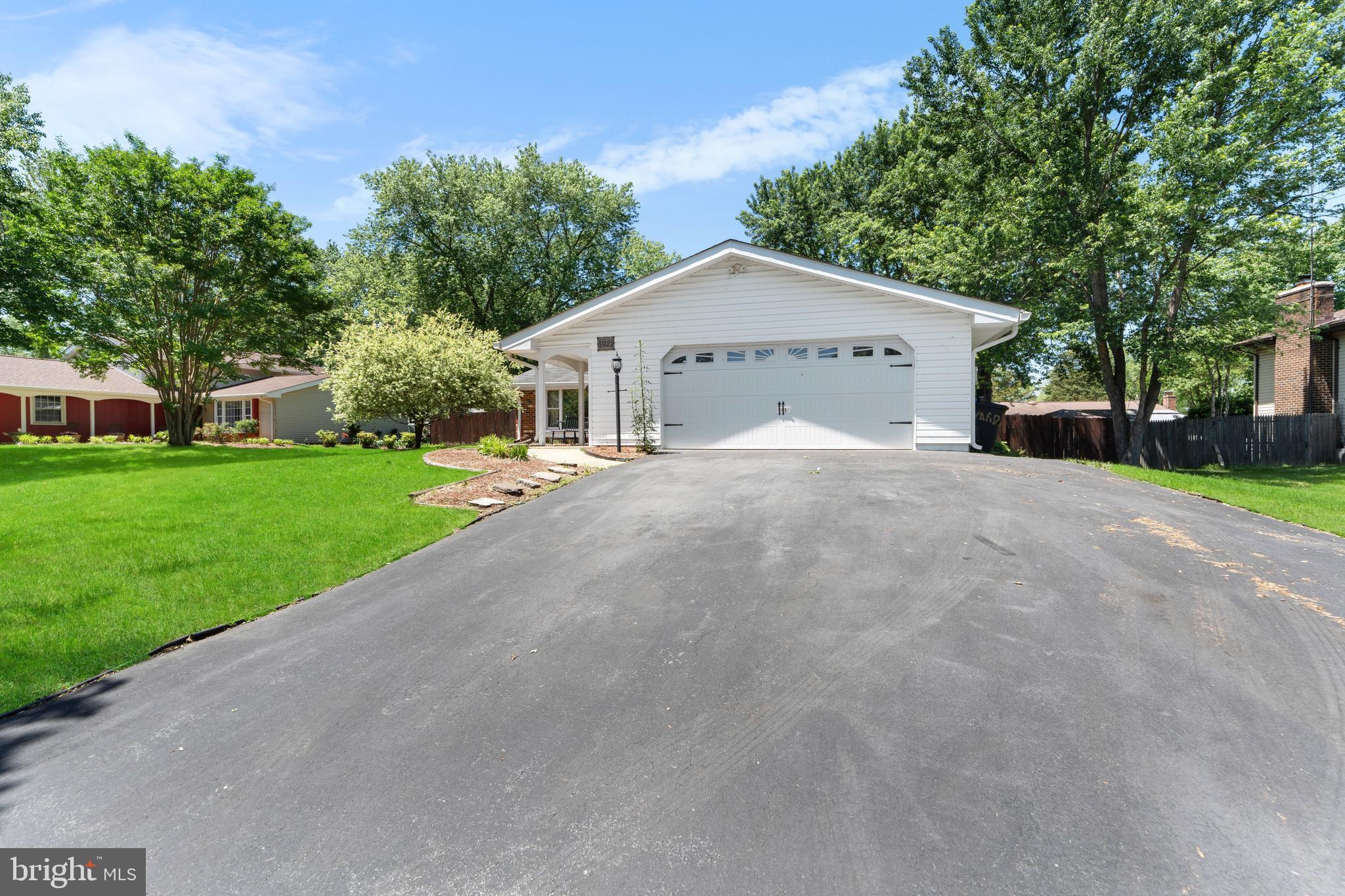 5922 Michael Road Waldorf, MD 20601 - Photo 2 of 43 a view of a house with a yard and large trees
