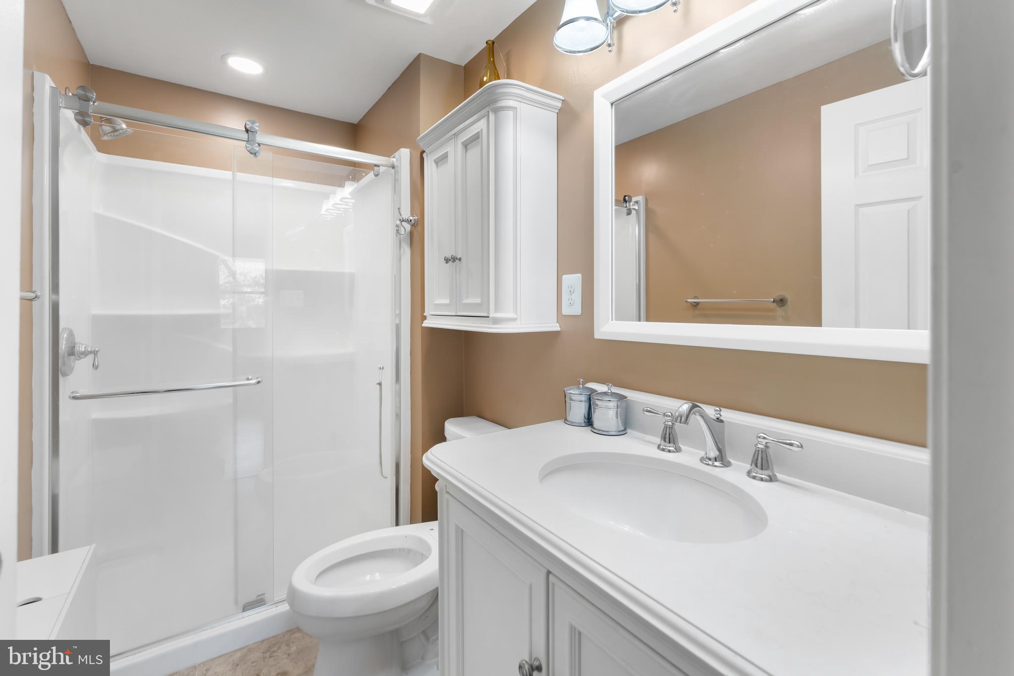 5922 Michael Road Waldorf, MD 20601 - Photo 22 of 43 a bathroom with a sink toilet and shower