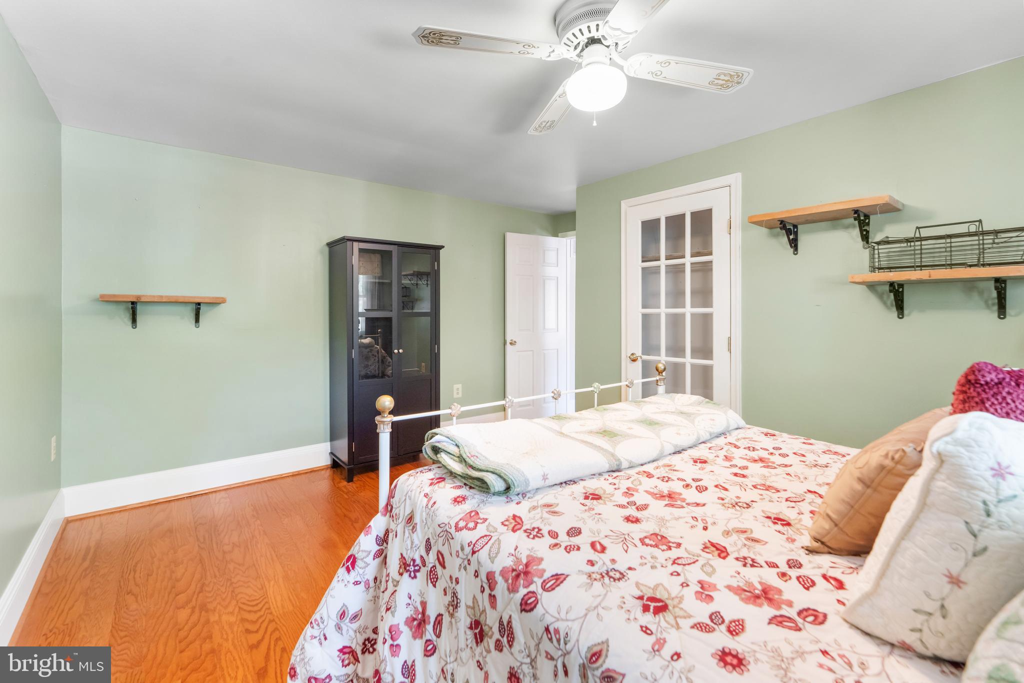 5922 Michael Road Waldorf, MD 20601 - Photo 26 of 43 a bedroom with a bed and a chandelier