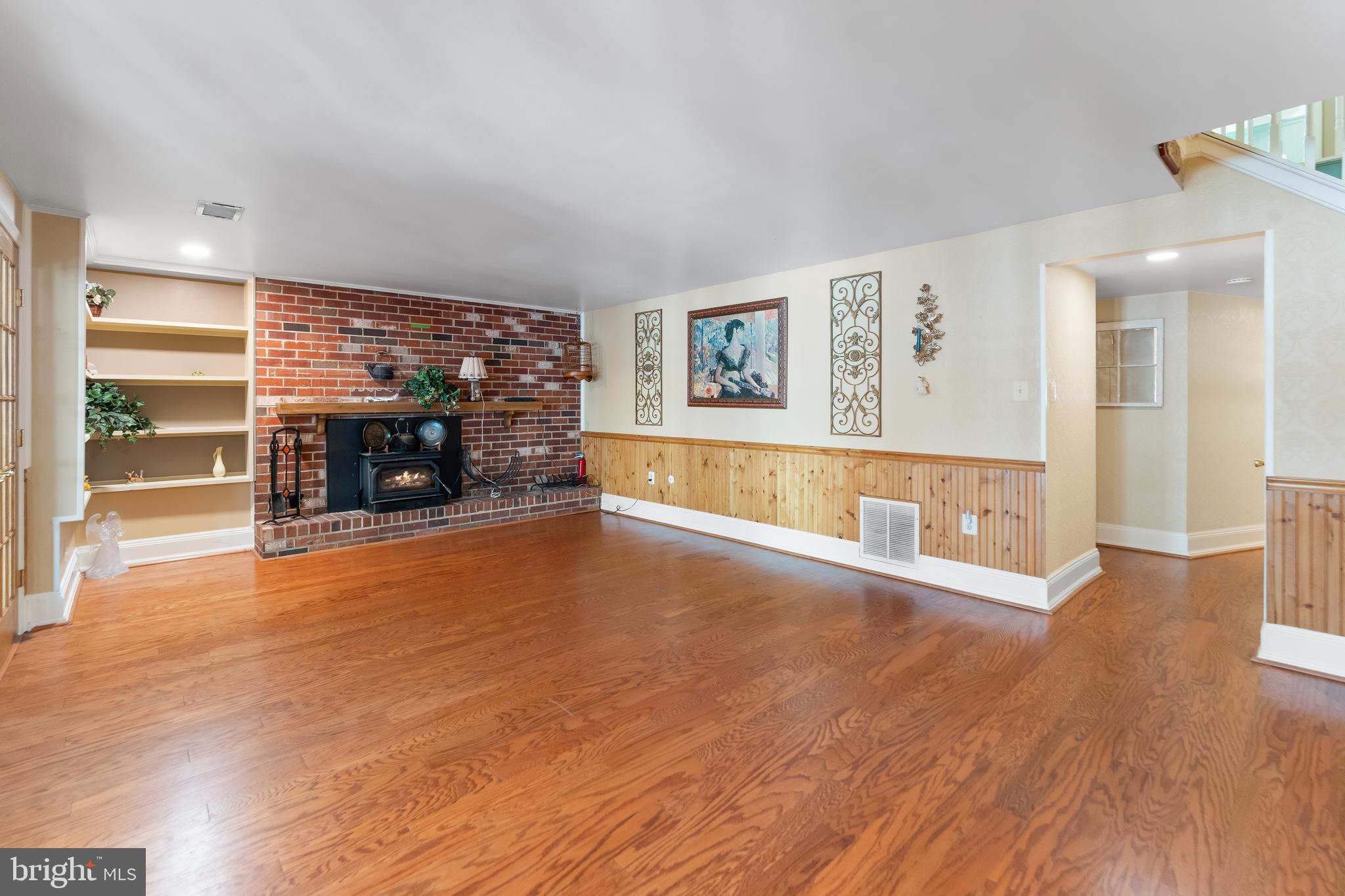 5922 Michael Road Waldorf, MD 20601 - Photo 29 of 43 an empty room with wooden floor and fireplace