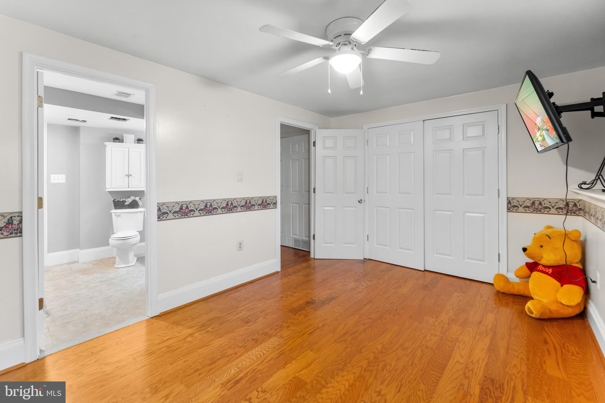 5922 Michael Road Waldorf, MD 20601 - Photo 34 of 43 a view of a livingroom with wooden floor and a chandelier fan