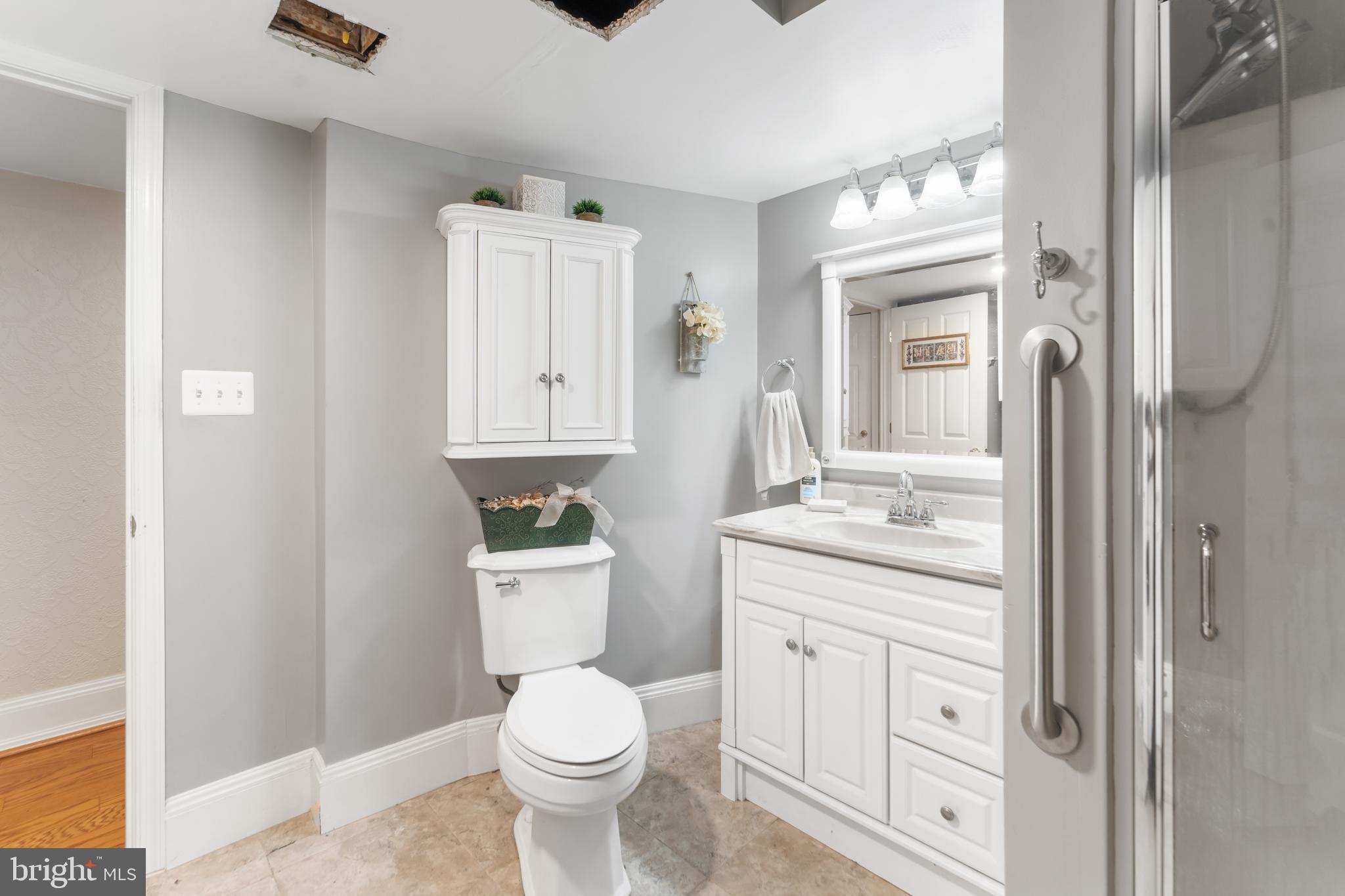 5922 Michael Road Waldorf, MD 20601 - Photo 35 of 43 a bathroom with a toilet a sink and a mirror