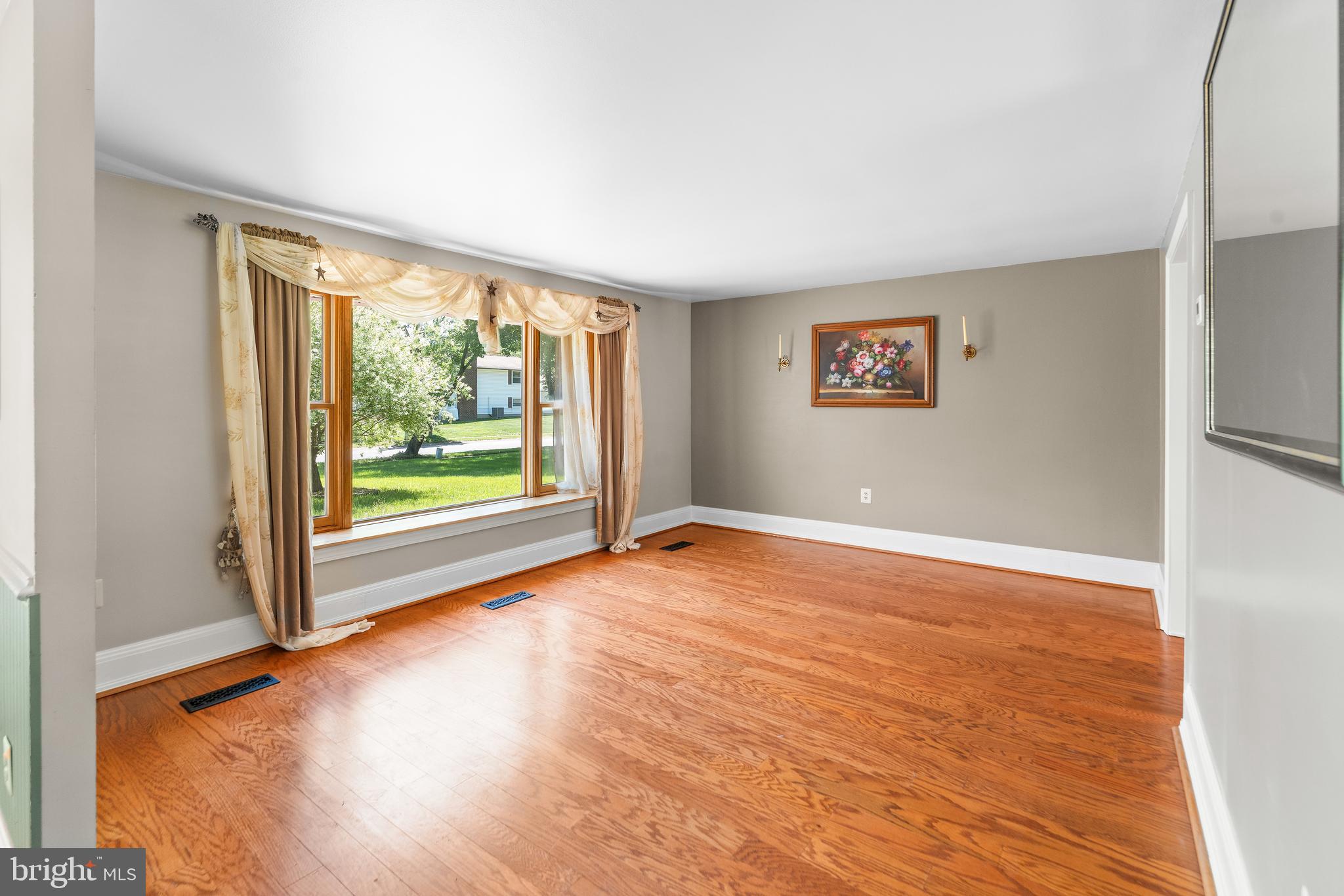 5922 Michael Road Waldorf, MD 20601 - Photo 9 of 43 an empty room with wooden floor and windows