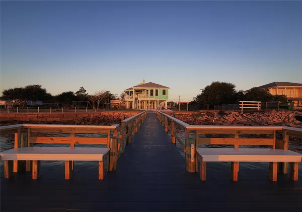 a roof deck with table and chairs a barbeque with wooden floor