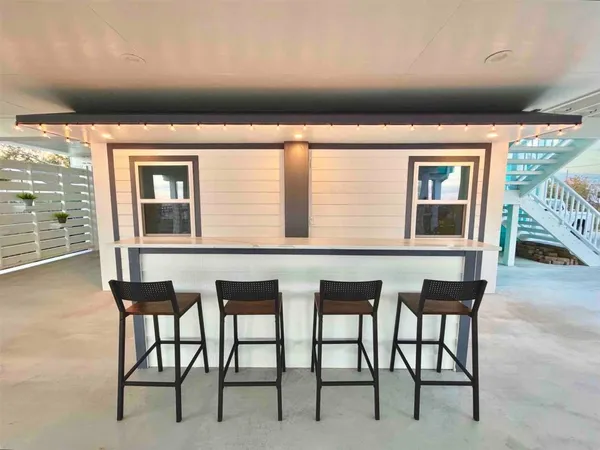 a balcony with table and chairs