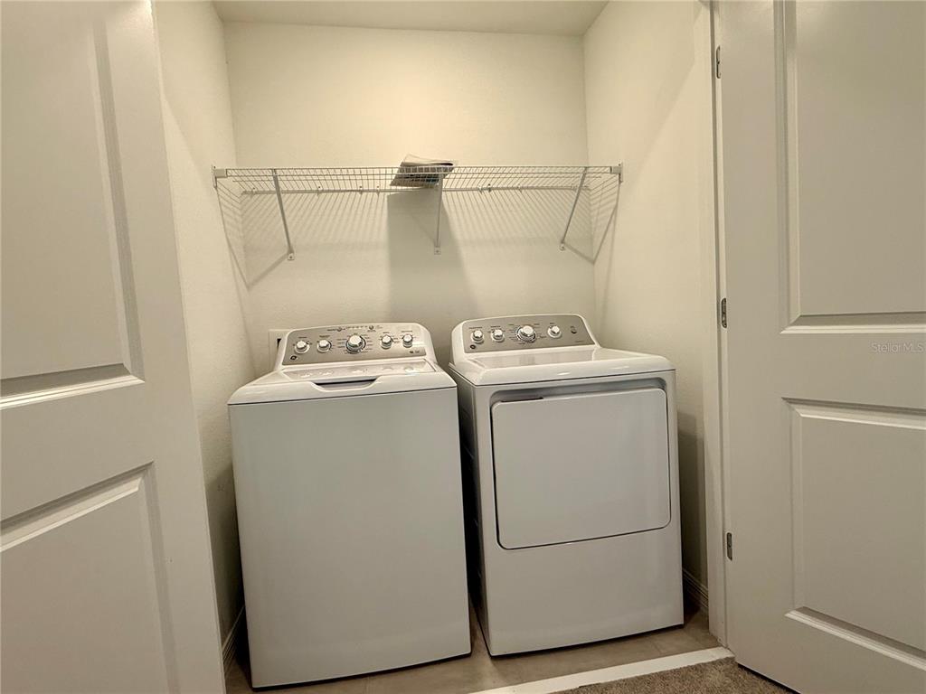 2996 Skyline Loop Kissimmee, FL 34758 - Photo 13 of 26 a utility room with dryer and washer