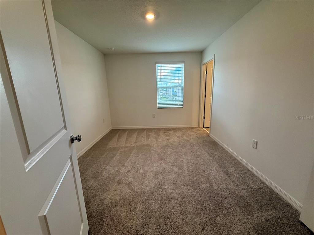 2996 Skyline Loop Kissimmee, FL 34758 - Photo 19 of 26 an empty room with windows