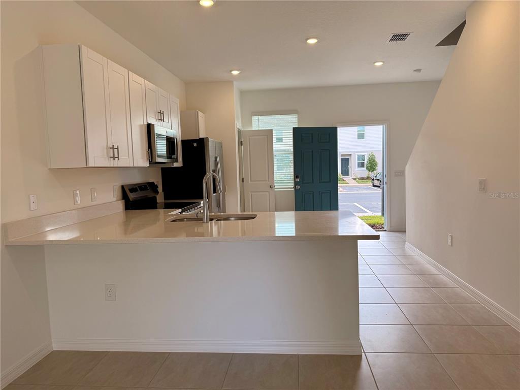 2996 Skyline Loop Kissimmee, FL 34758 - Photo 2 of 26 a view of a kitchen with cabinets