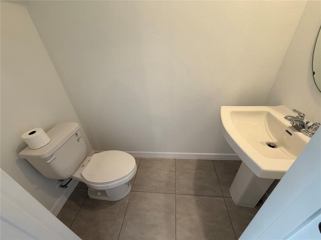 2996 Skyline Loop Kissimmee, FL 34758 - Photo 9 of 26 a bathroom with a toilet sink and mirror