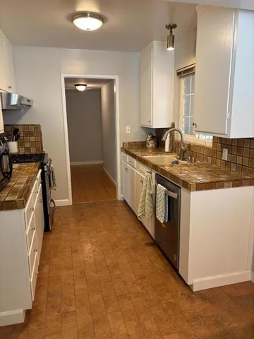 a kitchen with a stove sink and a refrigerator