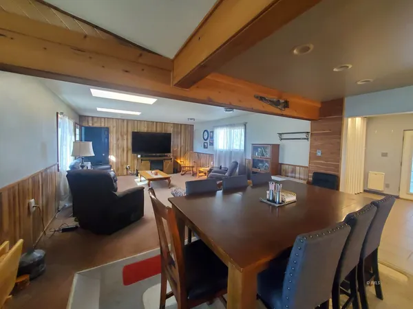 a living room with lots of furniture and clutter