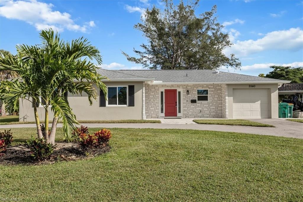 3560 Corana Way Naples, FL 34105 - Photo 1 of 24 a house that has a big yard large trees and plants