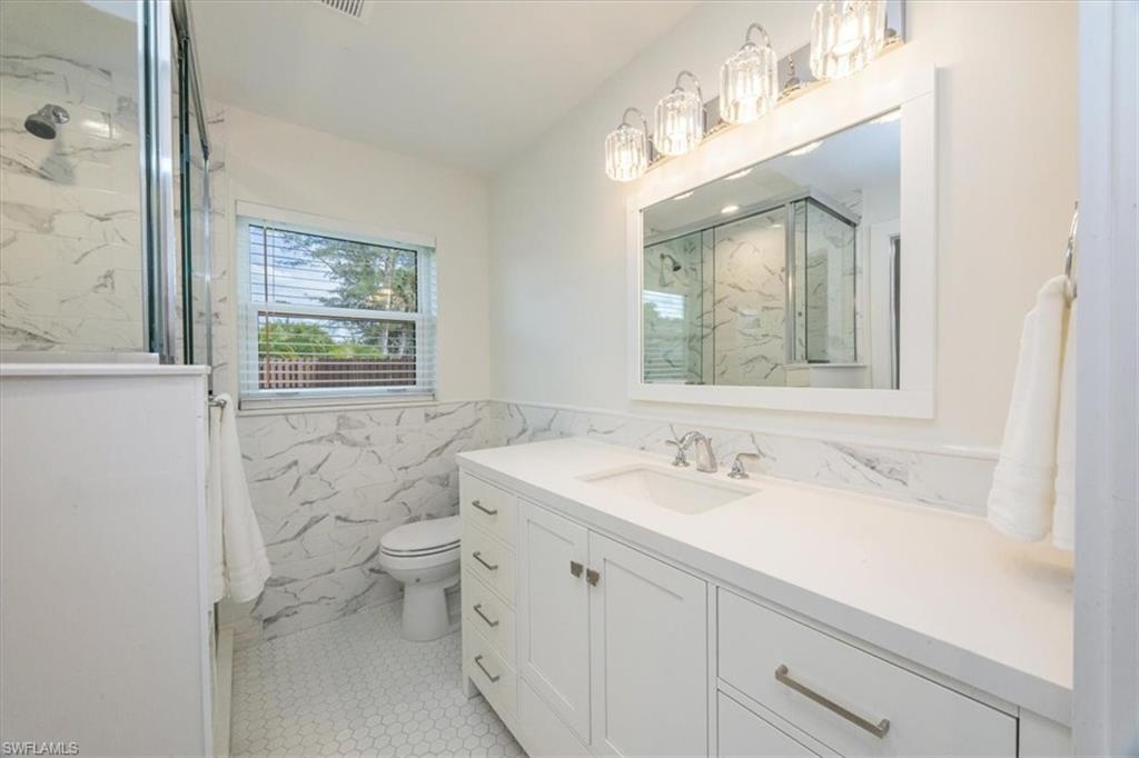 3560 Corana Way Naples, FL 34105 - Photo 14 of 24 a bathroom with a sink toilet and shower