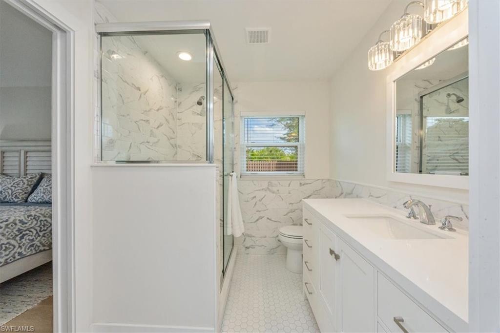 3560 Corana Way Naples, FL 34105 - Photo 15 of 24 a bathroom with a sink a toilet and shower