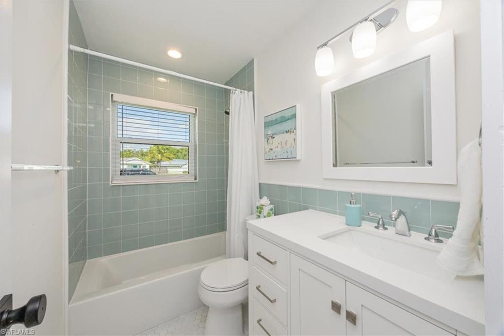 3560 Corana Way Naples, FL 34105 - Photo 18 of 24 a bathroom with a sink a toilet and shower